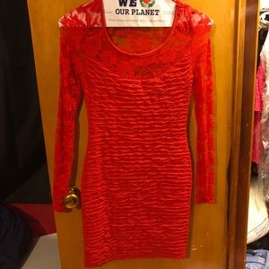 Form fitting red long sleeve dress.
